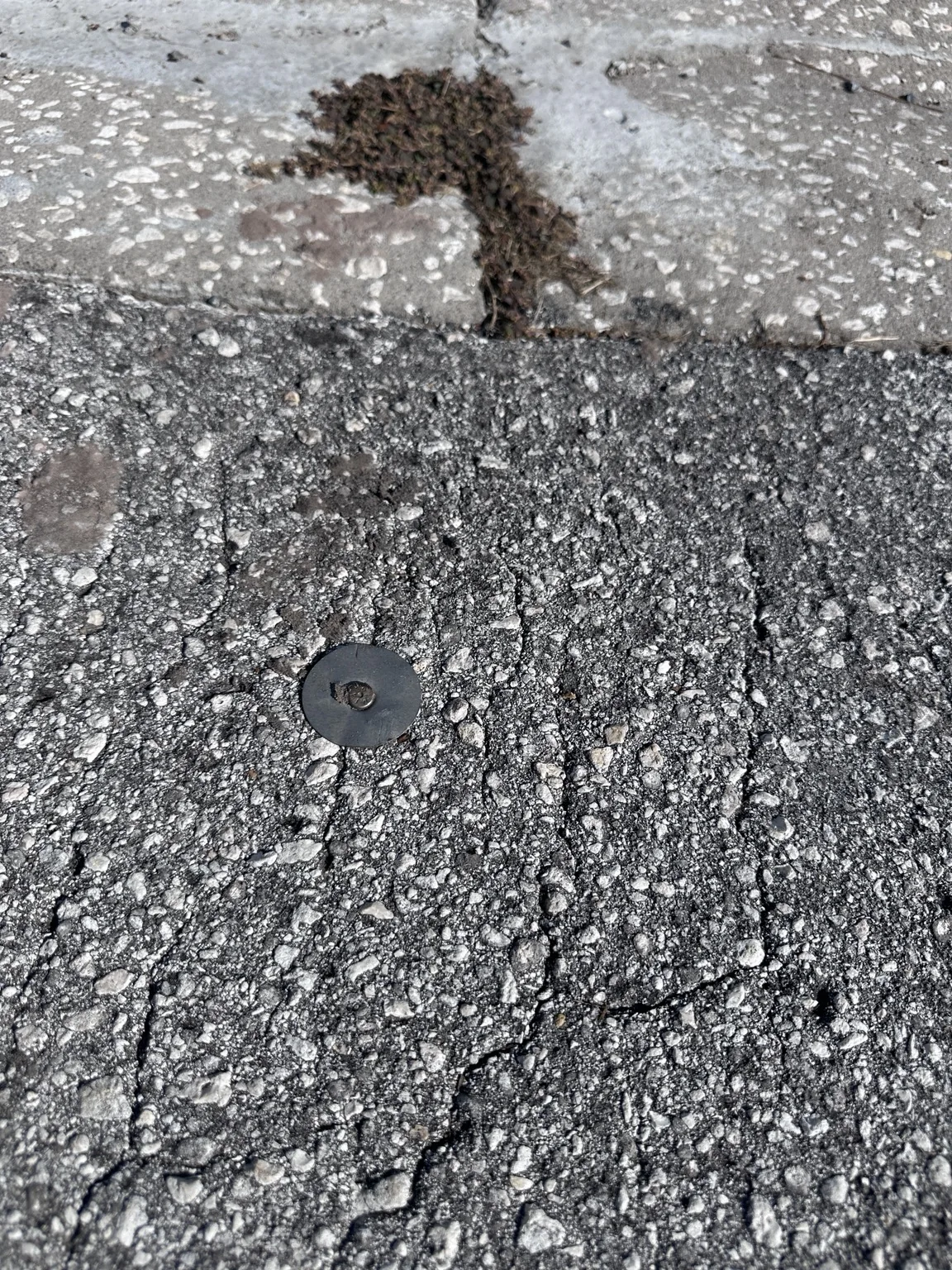 Property boundary survey marker set into pavement