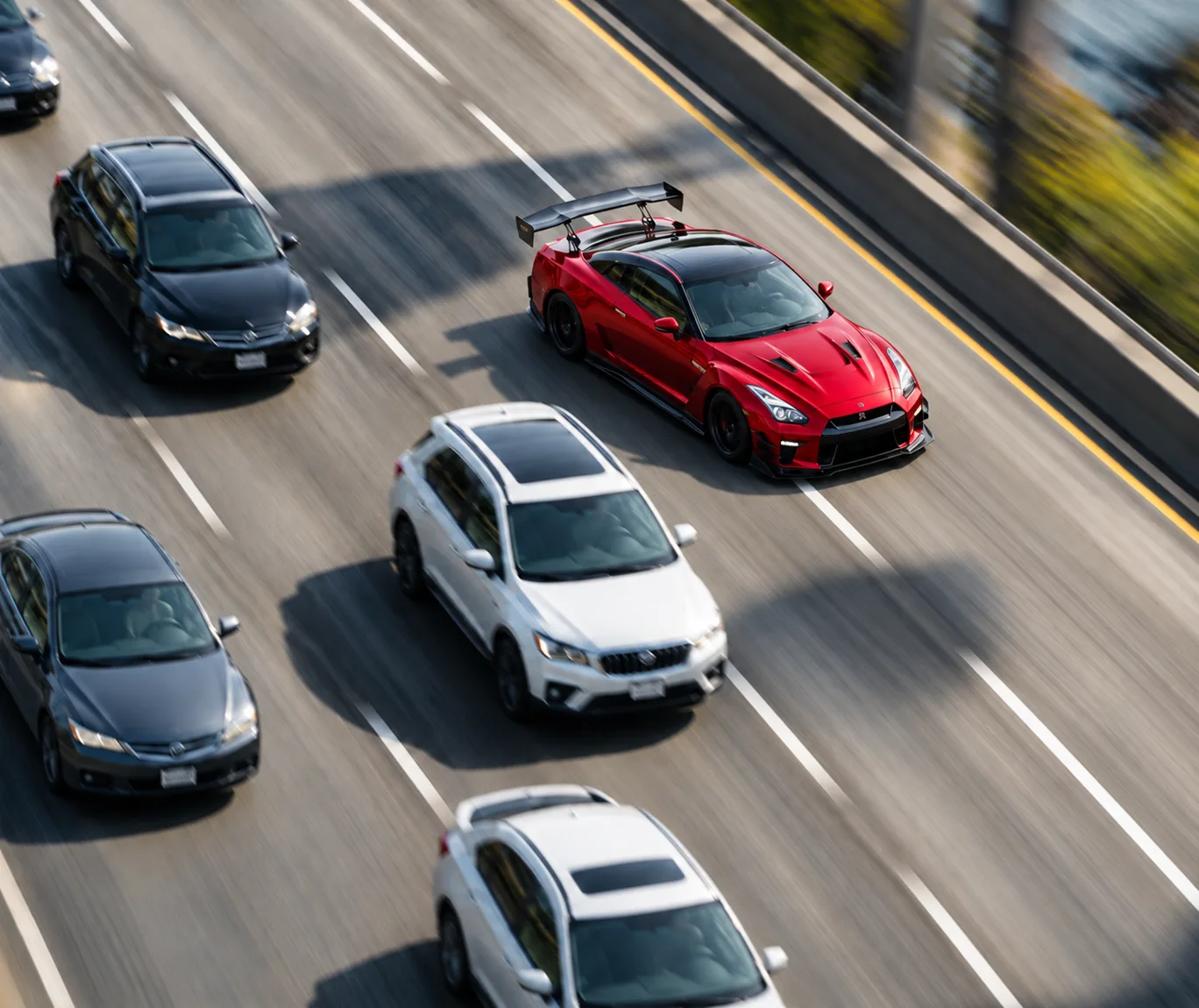 Red sports car angled across the dashed highway lane marking